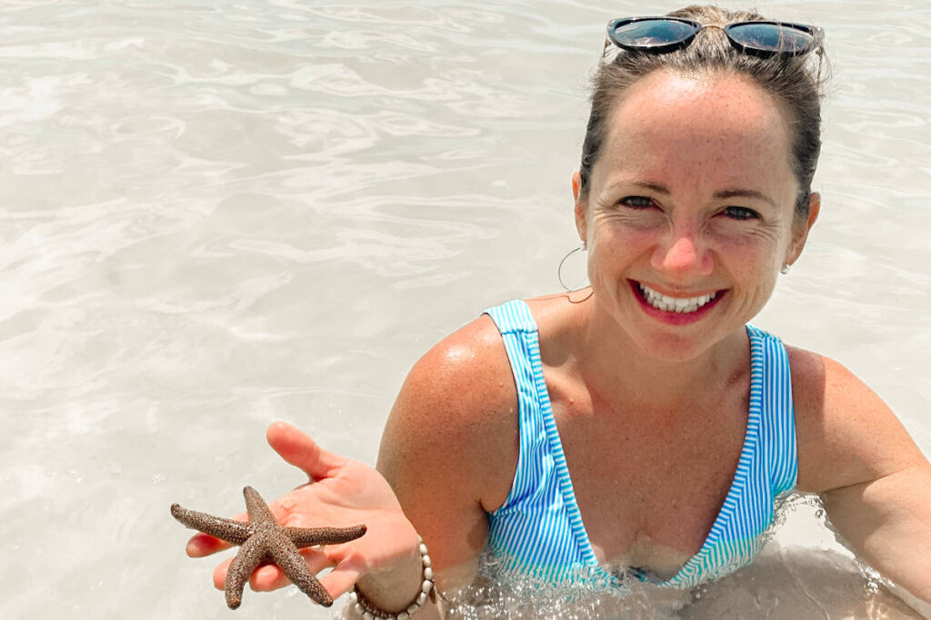 Island Life Excursions Tampa Boat Tours woman holding starfish